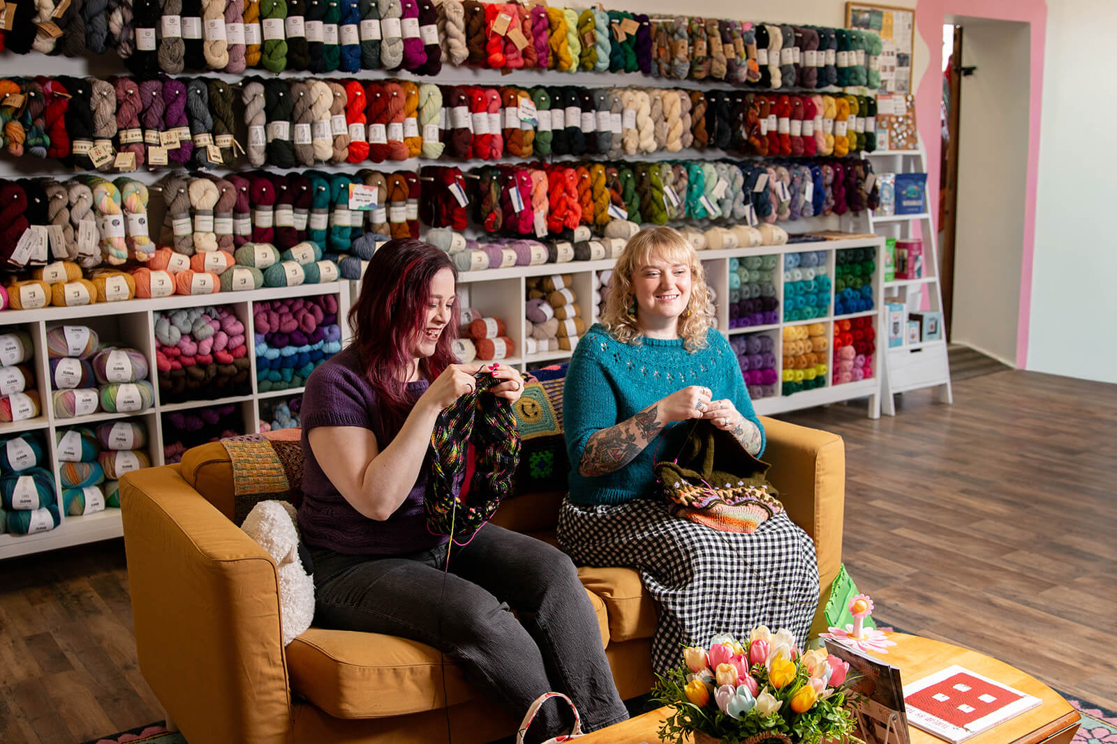 Lauren and Bryanne knitting in the shop